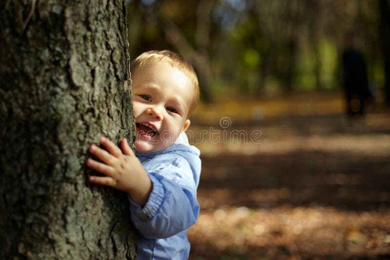 за мальчиком смеясь над peeking вал стоковые изображения