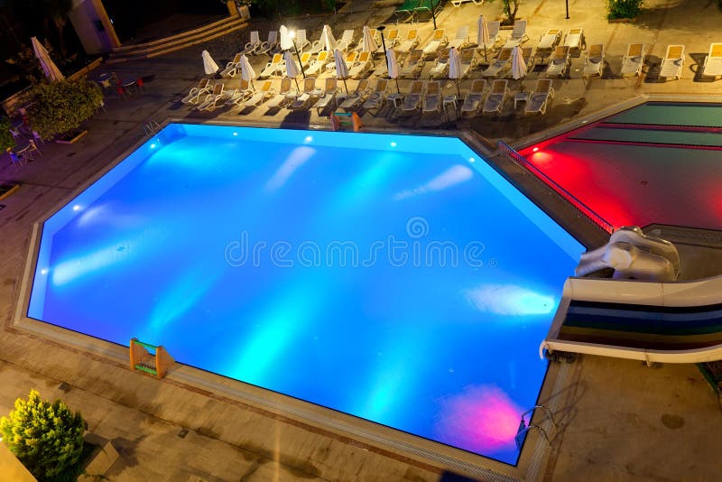 Illuminated swimming pool at night on tropical resort. Illuminated swimming pool at night on tropical resort