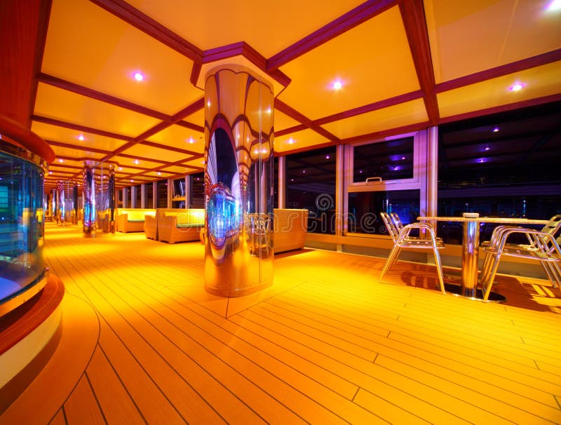 Interior of illuminated restaurant on cruise ship deck at night. Interior of illuminated restaurant on cruise ship deck at night