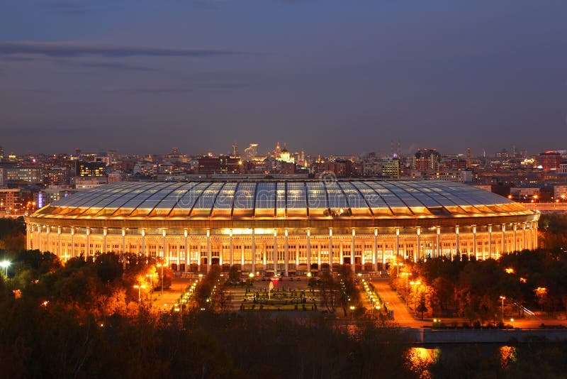 Illuminated Luzhniki Stadium at evening, panorama of Moscow from Vorobyovy Hills. Illuminated Luzhniki Stadium at evening, panorama of Moscow from Vorobyovy Hills