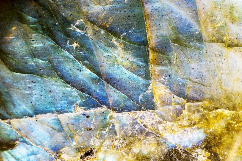 This is a macro photo of a blue and yellow crystal moonstone. I illuminated it from underneath to bring out the interesting mineral textures and patterns. This is a macro photo of a blue and yellow crystal moonstone. I illuminated it from underneath to bring out the interesting mineral textures and patterns.