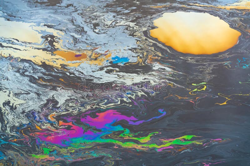 Загрязнение от цветного пятна нефти на поверхности воды стоковое изображение