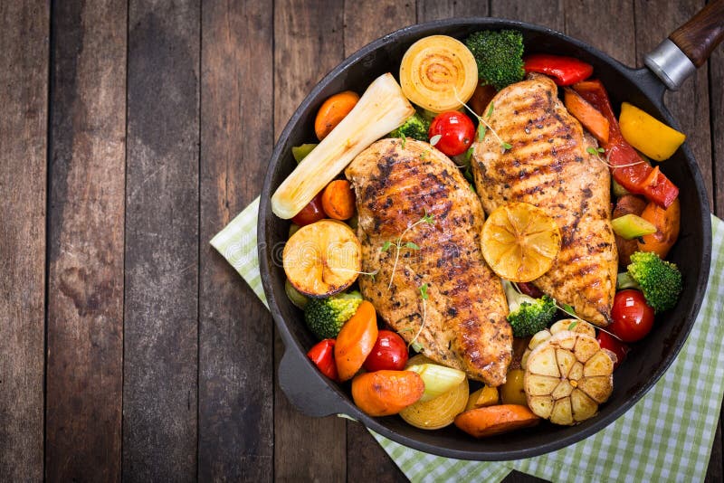Grilled chicken breast and vegetables in the pan. Grilled chicken breast and vegetables in the pan