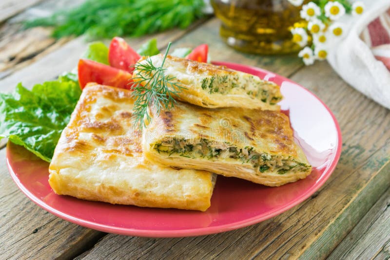 Зажаренный хлеб питы заполненный с цыпленком, сыром и травами служил на керамической плите : r стоковые изображения rf Зажаренный хлеб питы заполненный с цыпленком, сыром и травами служил на керамической плите : r стоковые изображения rf