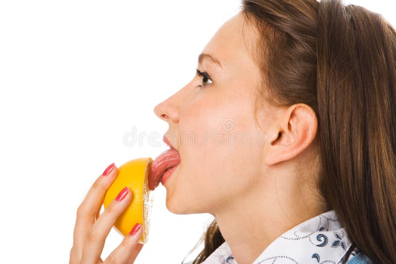 Close-up young woman lick orange over white. Close-up young woman lick orange over white