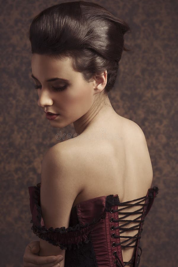 Sensual sweet portrait of beauty woman in old fashion style , looking down and showing her shoulder. Sensual sweet portrait of beauty woman in old fashion style , looking down and showing her shoulder