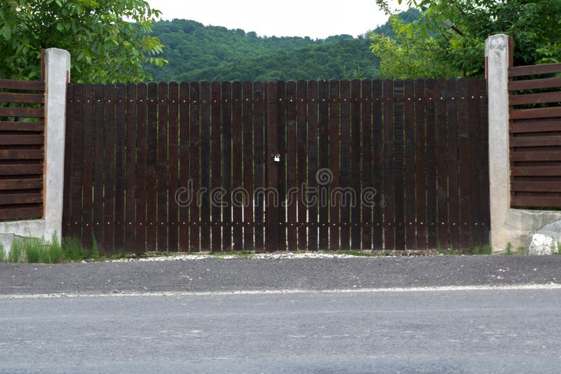 Closed wood gates that protects property in the mountains. Closed wood gates that protects property in the mountains.