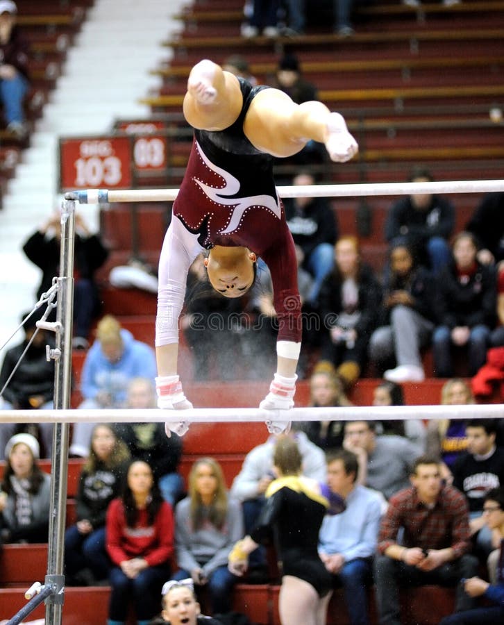 PHILADELPHIA - FEBRUARY 5: Temple University gymnast Kathryn Ho performs on the uneven bars amid a cloud of chalk in Philadelphia February 5, 2011. PHILADELPHIA - FEBRUARY 5: Temple University gymnast Kathryn Ho performs on the uneven bars amid a cloud of chalk in Philadelphia February 5, 2011.