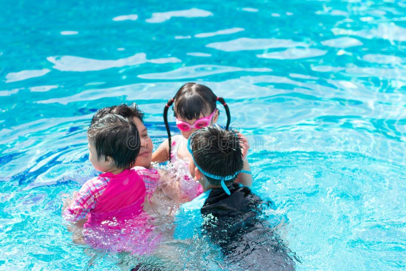 Happy family in swimming pool. Father and his 3 children 2 girls and 1 boy. Happy family in swimming pool. Father and his 3 children 2 girls and 1 boy.