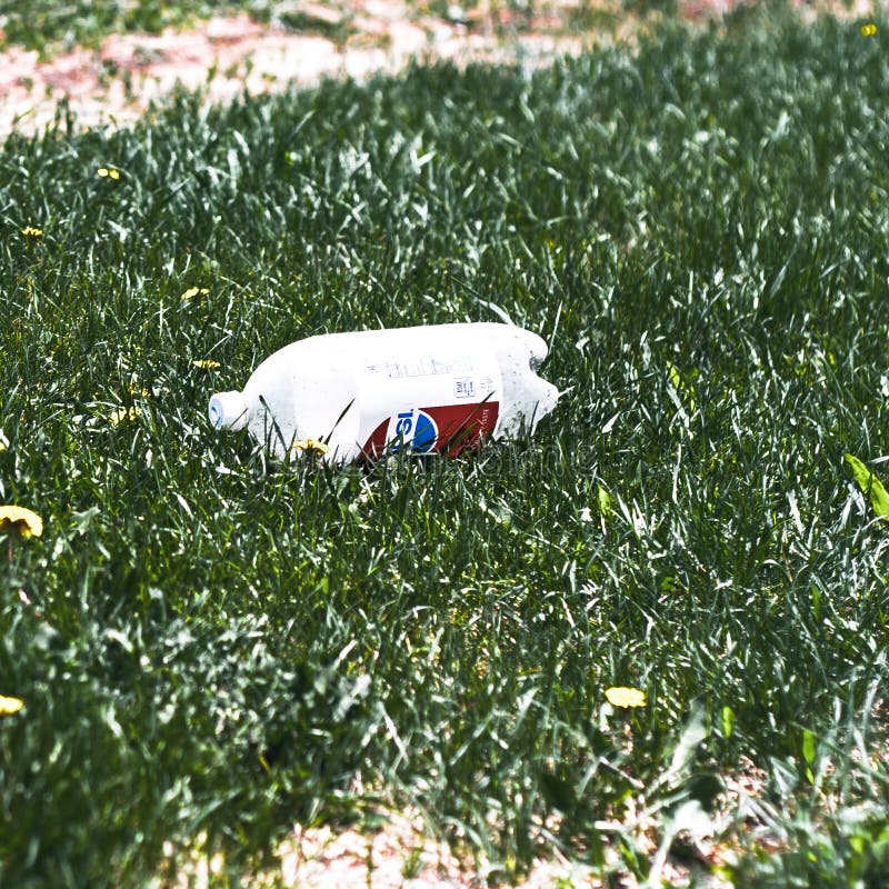 Littered close view of trashed 2 liter Pepsi Soda. Littered close view of trashed 2 liter Pepsi Soda