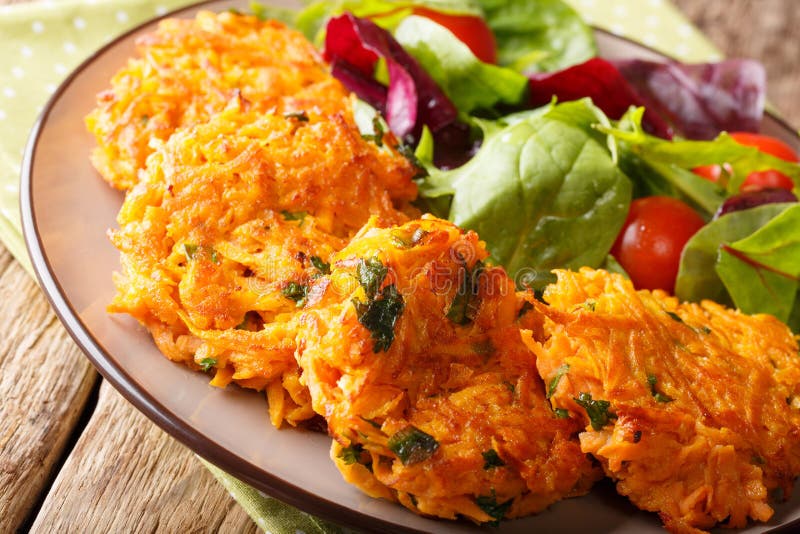 Здоровая еда: очень вкусные блинчики сладкого картофеля и свежий cl салата стоковое фото rf Здоровая еда: очень вкусные блинчики сладкого картофеля и свежий cl салата стоковое фото rf