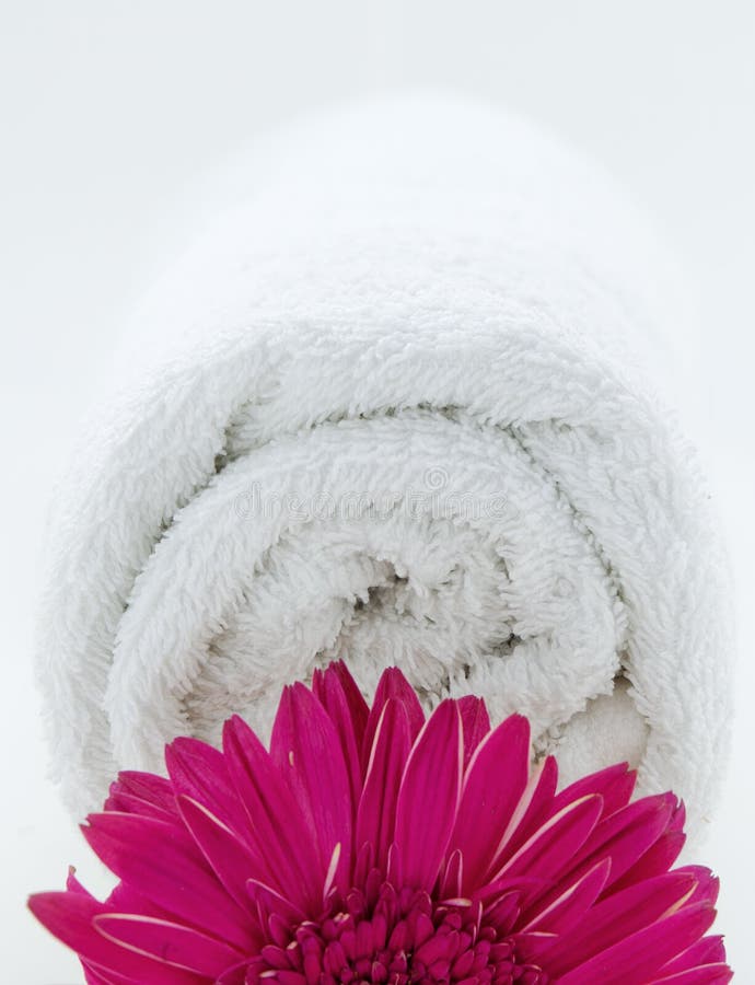 White towel role with flower close up. White towel role with flower close up