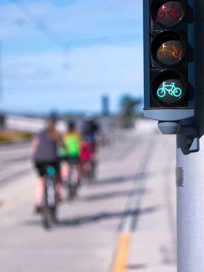 Green traffic light specifically for cyclists authorizing the movement of moving one by one on a flat straight road on their own bikes. Green traffic light specifically for cyclists authorizing the movement of moving one by one on a flat straight road on their own bikes