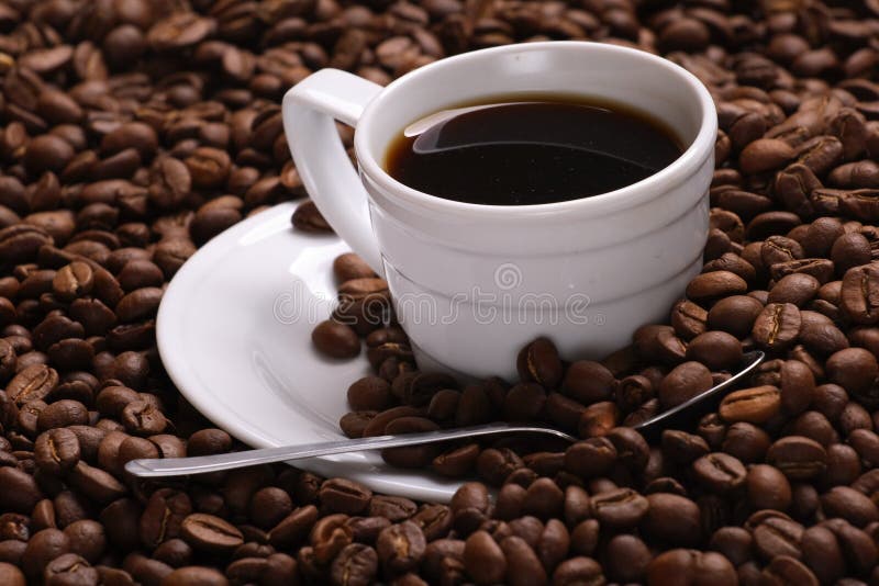 Cup with coffee, costing on coffee grain. Cup with coffee, costing on coffee grain