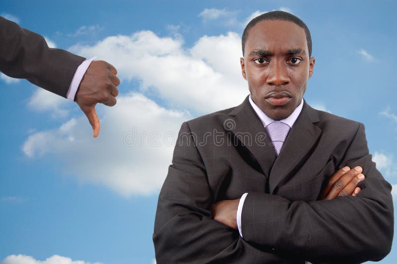 This is an image of an angry businessman who is trying to manage his anger. The thumbs down is a sign of discouragement. This image can be used to represent Poor Anger Management themes. This is an image of an angry businessman who is trying to manage his anger. The thumbs down is a sign of discouragement. This image can be used to represent Poor Anger Management themes