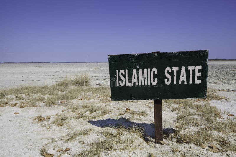 Dark sign in the desert with the words islamic state in white letters. Political concept concerning terrorism and the war in Syria and Iraq. Dark sign in the desert with the words islamic state in white letters. Political concept concerning terrorism and the war in Syria and Iraq