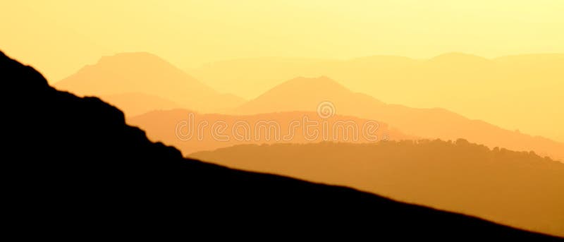 Layers of mountains with golden sunset banner. Layers of mountains with golden sunset banner.