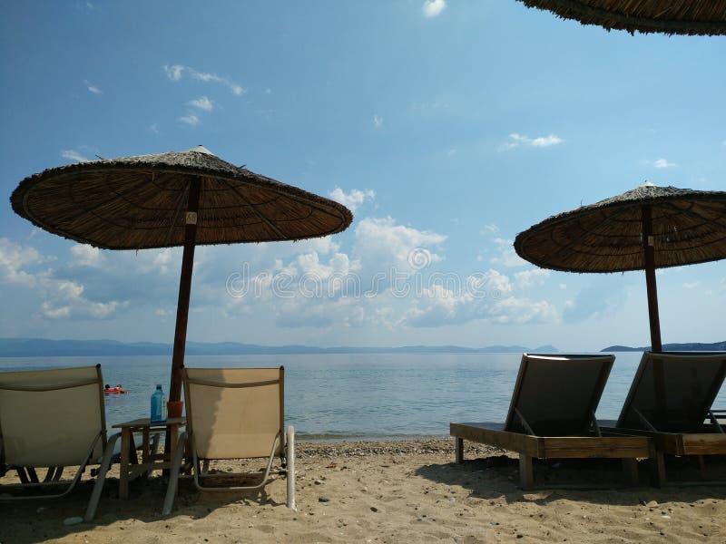 зонтики и кровати пляжа, Halkidiki Греция стоковые изображения rf зонтики и кровати пляжа, Halkidiki Греция стоковые изображения rf