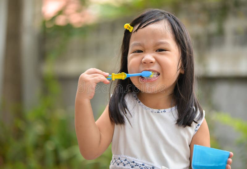 Cute Asian kid brushing teeth at home. Cute Asian kid brushing teeth at home