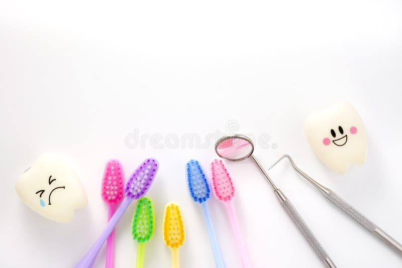 Teeth smile and crying emotion with dental mirror ,dental plaque cleaning tool and tooth brush, with copy space for your text. Teeth smile and crying emotion with dental mirror ,dental plaque cleaning tool and tooth brush, with copy space for your text