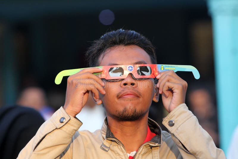 Citizens witnessed a solar eclipse using sunglasses in the city of Solo, Central Java, Indonesia. Citizens witnessed a solar eclipse using sunglasses in the city of Solo, Central Java, Indonesia