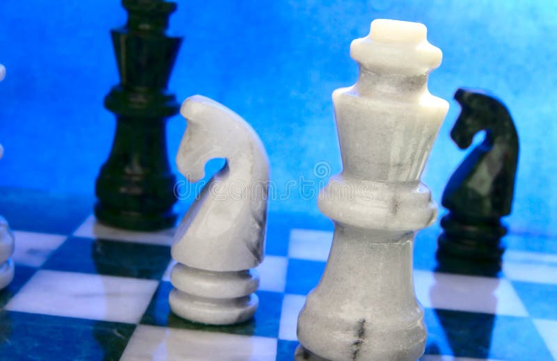 Chess pieces arranged on blue background. Chess pieces arranged on blue background