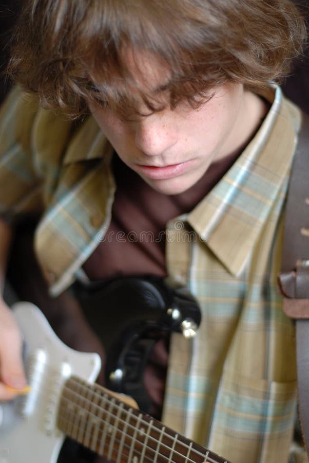 Fourteen year old boy playing electric guitar. Fourteen year old boy playing electric guitar