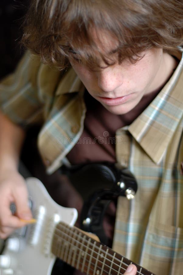 Fourteen year old boy playing electric guitar. Fourteen year old boy playing electric guitar