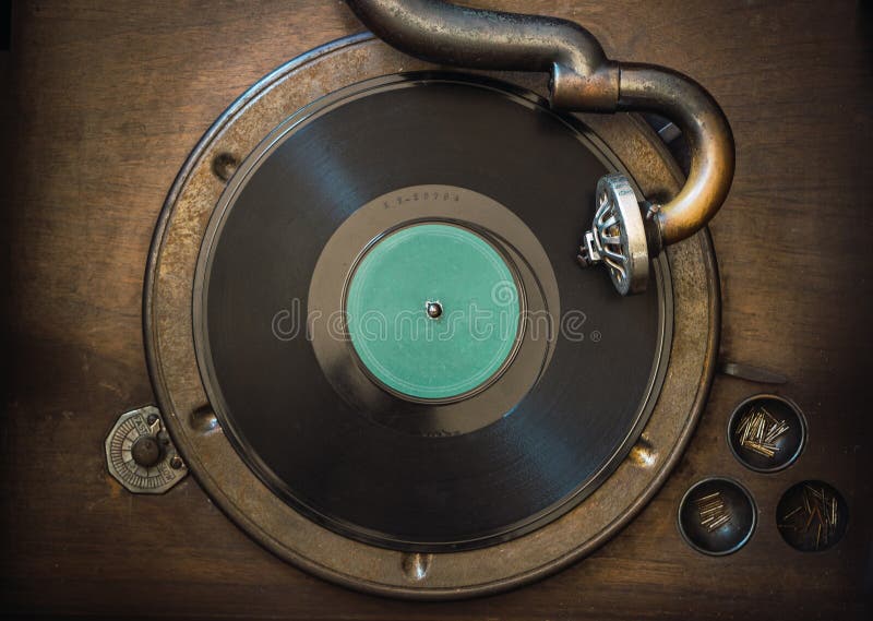 Detail of 1920`s old manual analog vinyl record player and disc. Detail of 1920`s old manual analog vinyl record player and disc