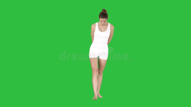 Идти молодой женщины белый и смотреть вниз на зеленом экране, ключе Chroma акции видеоматериалы
