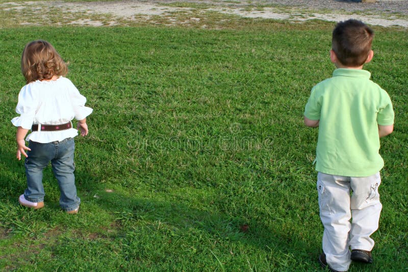 Young brother and sister walking away in opposite directions. Young brother and sister walking away in opposite directions.