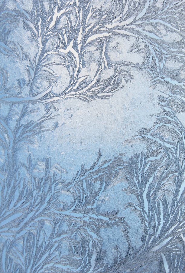 Feathery frost pattern - ice flowers on window glass. Feathery frost pattern - ice flowers on window glass.