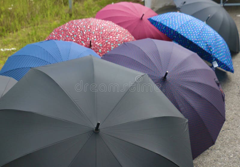 Detail of several umbrellas in which stand out their fabrics of different colors and different types, some light and waterproof, vinyl, heavier but resistant or more resistant reinforced polyester. Detail of several umbrellas in which stand out their fabrics of different colors and different types, some light and waterproof, vinyl, heavier but resistant or more resistant reinforced polyester.