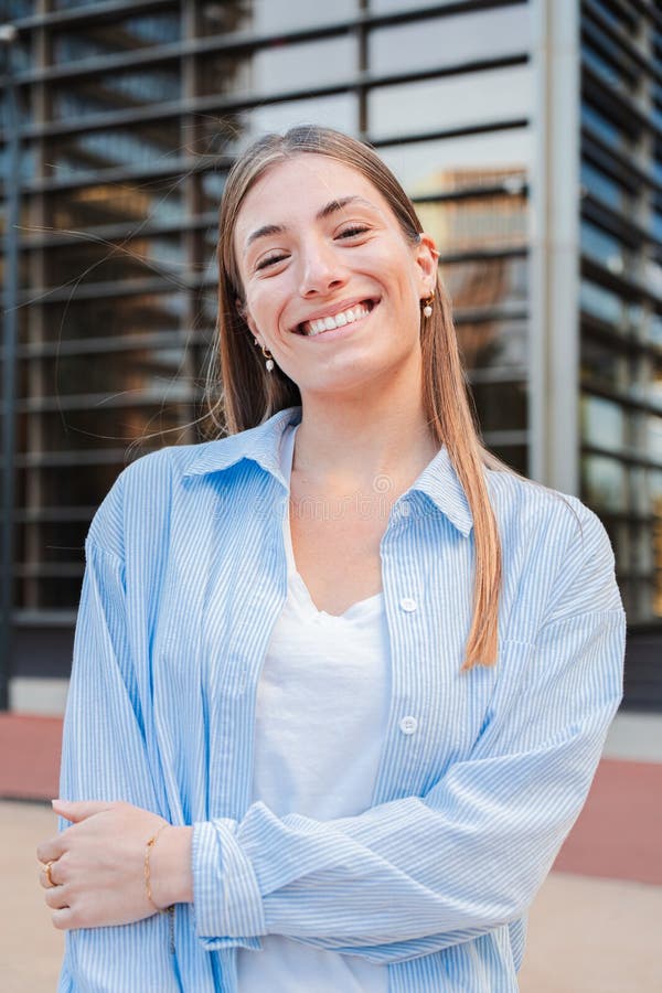 Vertical individual portrait of a joyful and adorable teenage blonde woman with friendly expression. Happy caucasian young female student looking at camera enjoying smiling with a perfect white teeth. High quality photo. Vertical individual portrait of a joyful and adorable teenage blonde woman with friendly expression. Happy caucasian young female student looking at camera enjoying smiling with a perfect white teeth. High quality photo