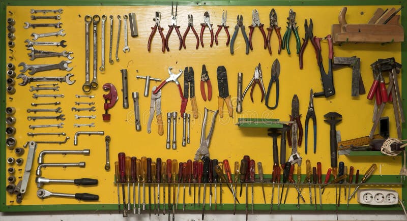 Great variety of different types of tools exposed on a big yellow board. Great variety of different types of tools exposed on a big yellow board.