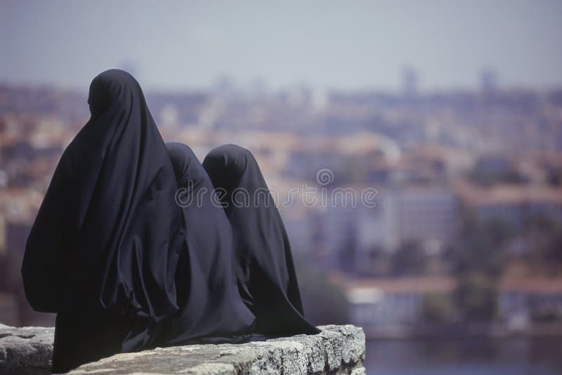 Three Islamic women dressed in black turning their back. Istanbul, Turkey. Three Islamic women dressed in black turning their back. Istanbul, Turkey