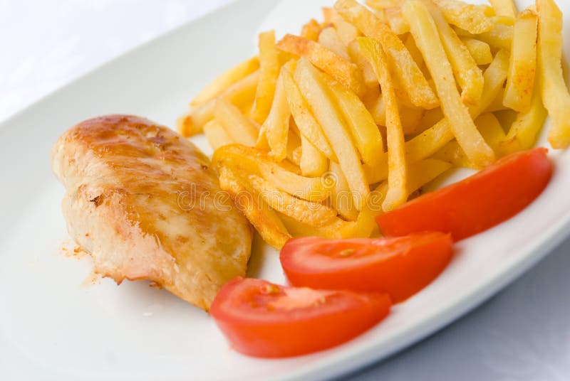 Baked chicken breast with french fried tomatoes. Baked chicken breast with french fried tomatoes.