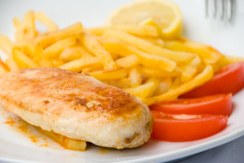 Baked chicken breast with french fried tomatoes. Baked chicken breast with french fried tomatoes.