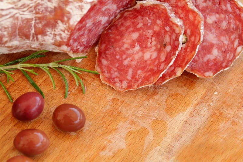 Italian food - salami, rosemary and olives. Italian food - salami, rosemary and olives