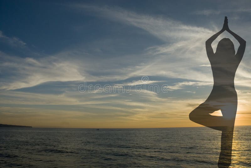 Silhouette of woman in yoga position on a beach with dramatic sky. Silhouette of woman in yoga position on a beach with dramatic sky