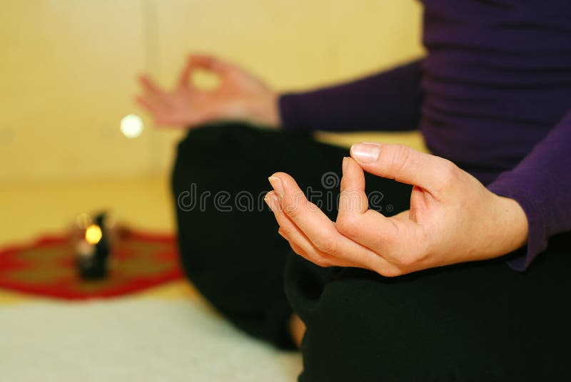 Closeup of seated person meditating in Yoga position with upturned palms. Closeup of seated person meditating in Yoga position with upturned palms.