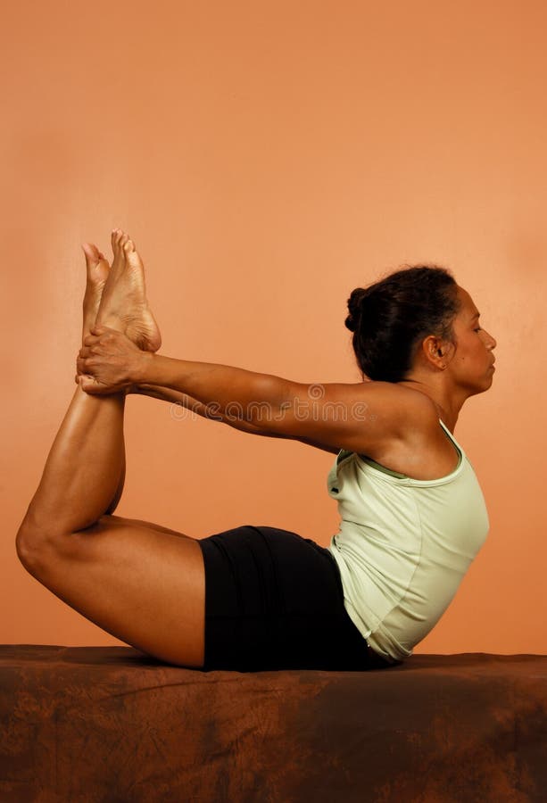 Hatha yoga pose spinal bend holding legs. Hatha yoga pose spinal bend holding legs