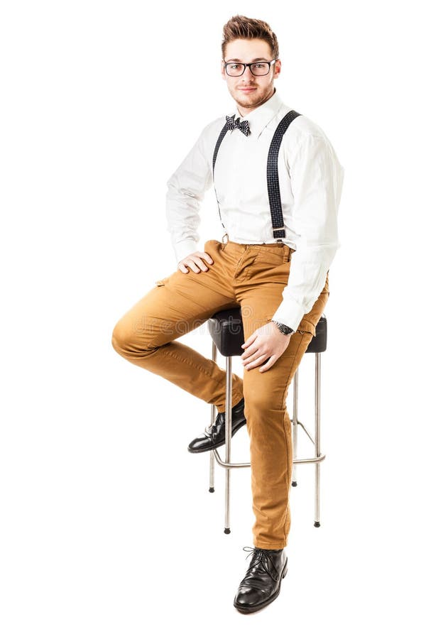 A handsome young man or hipster with braces and a bow tie isolated over a white background. A handsome young man or hipster with braces and a bow tie isolated over a white background