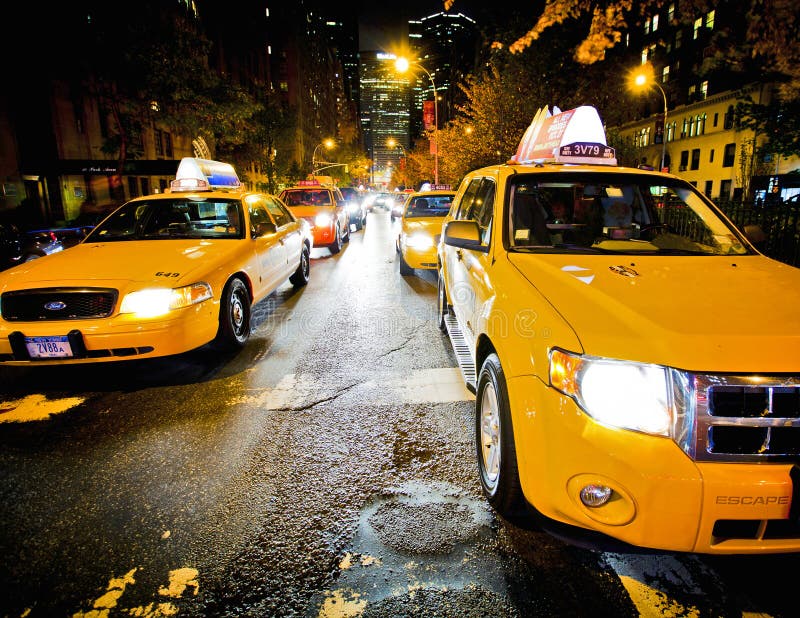 NEW YORK - NOVEMBER 11: Yellow NYC taxi cab in New York City on November 11, 2011. The taxicabs of New York City are a widely recognized icon of the city. NEW YORK - NOVEMBER 11: Yellow NYC taxi cab in New York City on November 11, 2011. The taxicabs of New York City are a widely recognized icon of the city.