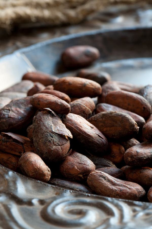 Cocoa (cacao) beans on iron dish, close-up. Cocoa (cacao) beans on iron dish, close-up