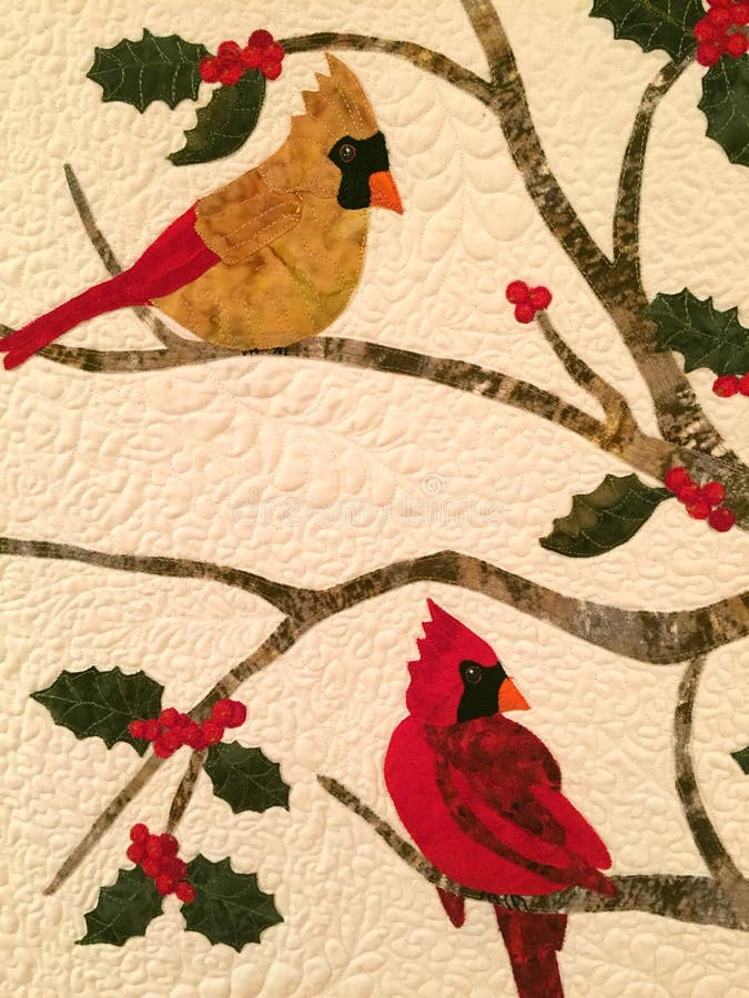 Quilted male and female cardinals on holly tree quilt design exhibited in Arkansas Historic Museum. Quilted male and female cardinals on holly tree quilt design exhibited in Arkansas Historic Museum