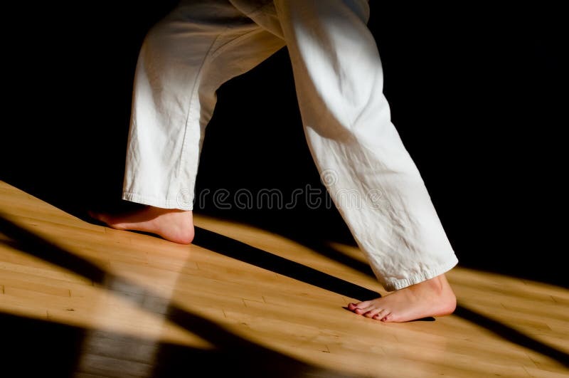 Legs and feet of a female karate student. Legs and feet of a female karate student
