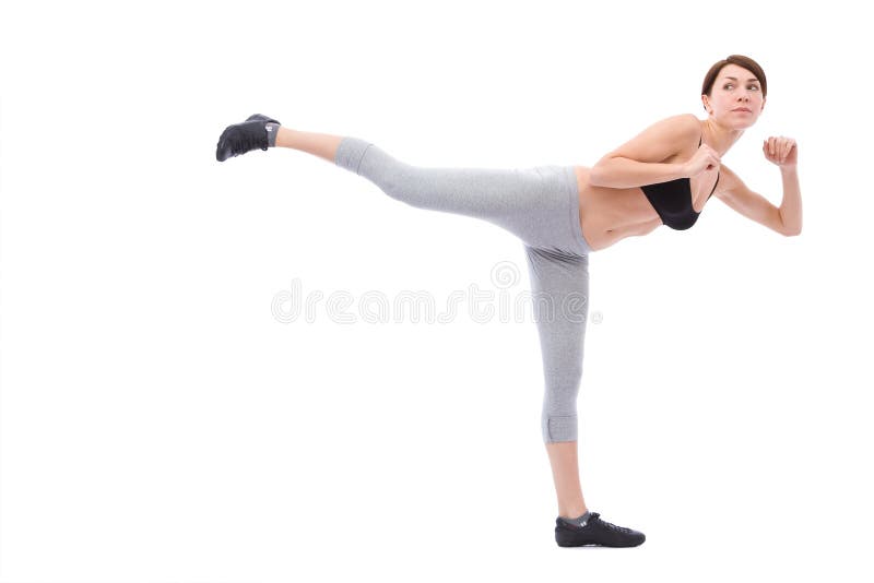 Beautiful woman doing a karate exercises on white background. Beautiful woman doing a karate exercises on white background