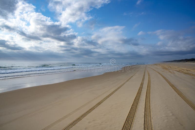 4WD Tire Tracks on Fraser Island Beach driving on the long Wide Beach of Great Sandy National Park, Queensland Australia. 4WD Tire Tracks on Fraser Island Beach driving on the long Wide Beach of Great Sandy National Park, Queensland Australia.