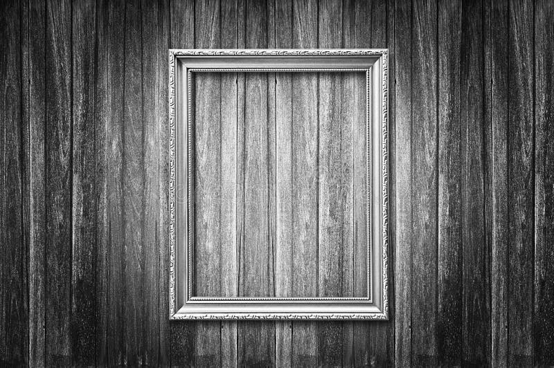 Old picture frame on dark wooden wall - monochrome. Old picture frame on dark wooden wall - monochrome